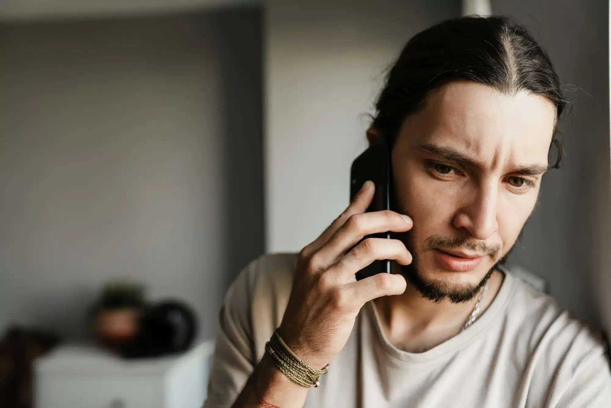 close-up-of-a-concerned-mman-talking-on-mobile-phone.webp