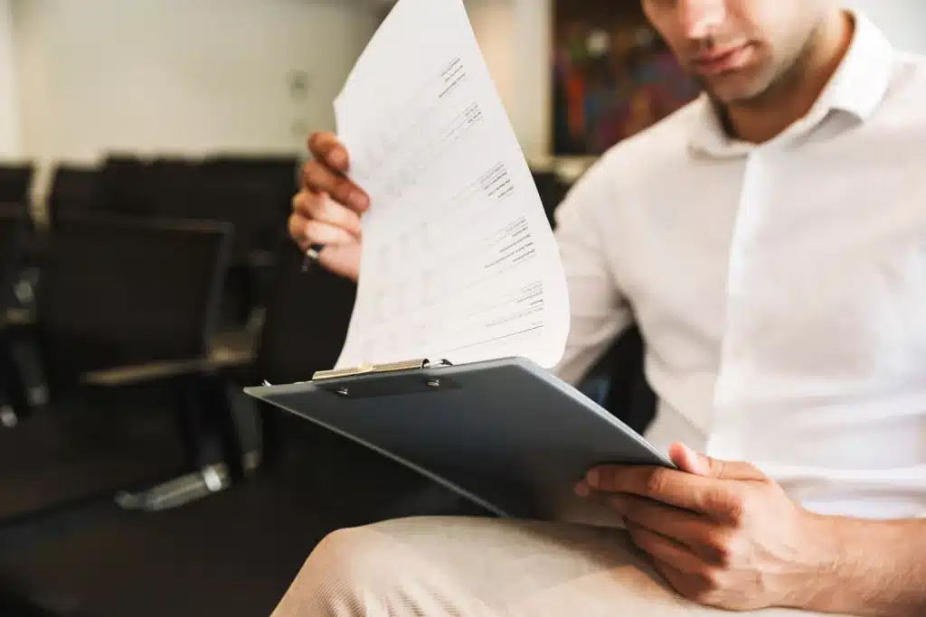 Person reviewing documents in meeting room.