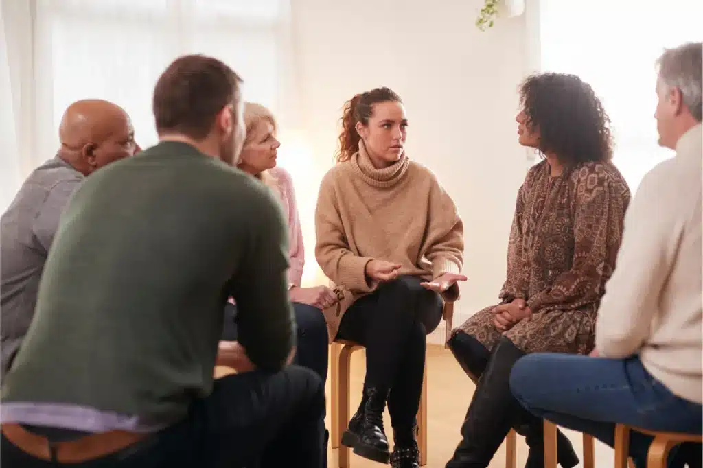 Supportive Alcoholics Anonymous meeting discussion in circle.