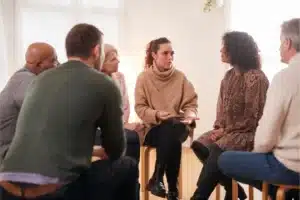 Supportive Alcoholics Anonymous meeting discussion in circle.