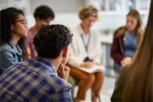 Supportive group addiction treatment session in progress.