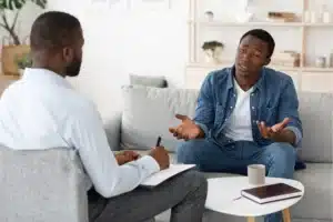 Two men engaged chemical dependency evaluation.