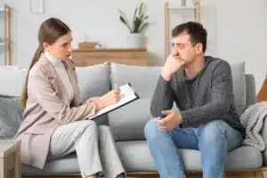 Therapist discussing drug dependence with a client.