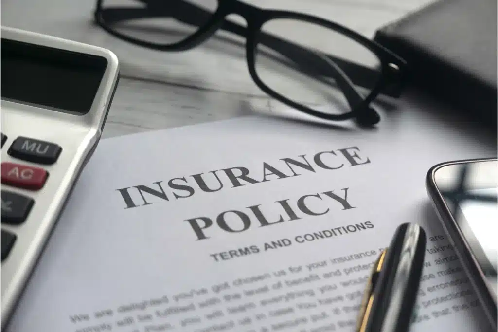 Insurance policy document with accessories.