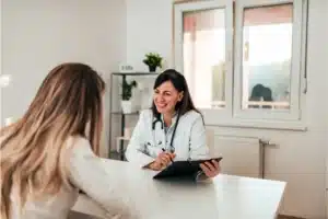 Doctor consulting patient in office.