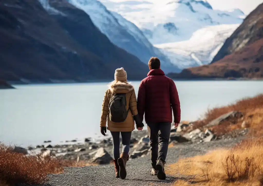 Couple walking hand in hand outdoors.
