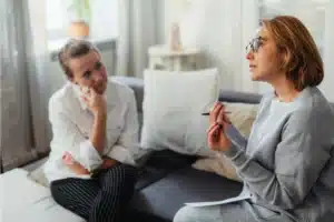 Therapy session for prescription drug addiction treatment between two individuals.