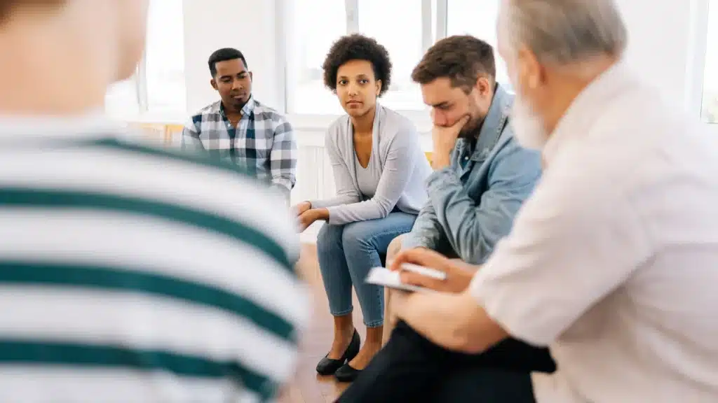 Support group discussion in bright room.