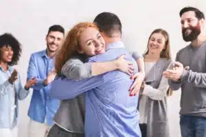 Supportive group celebrating a drug rehabilitation recovery.