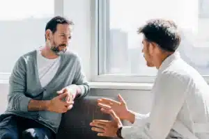 Two people engaged in substance abuse treatment conversation.