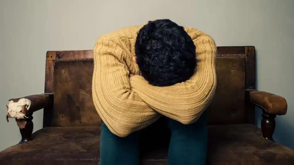 Person experiencing fatigue and emotional crash during meth withdrawal.