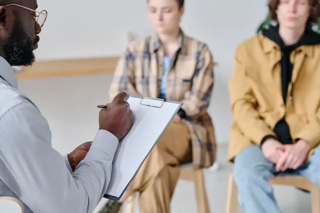 Counselor conducting an initial assessment during a substance abuse therapy session in New Jersey.