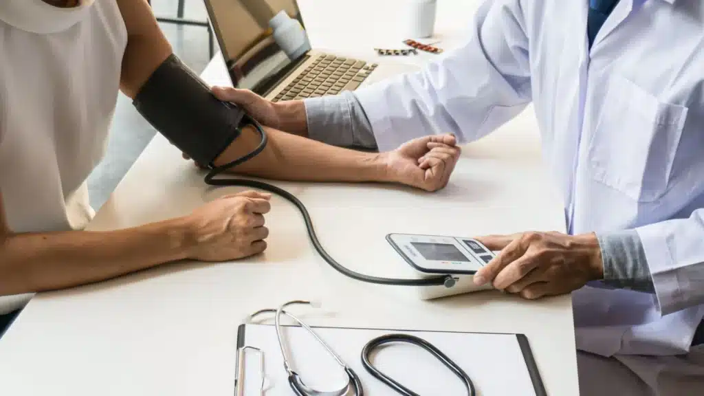 Healthcare provider taking a patient’s blood pressure as part of a medical assessment in a New Jersey meth treatment program.