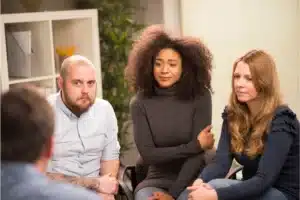 Group therapy session with individuals sharing experiences during meth addiction treatment in New Jersey.