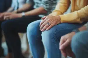 People sitting in a support group at a rehab for substance abuse.