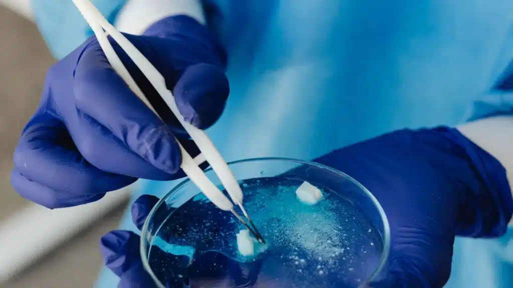 Person dissolving a sample and using a fentanyl test strip to detect contaminants.